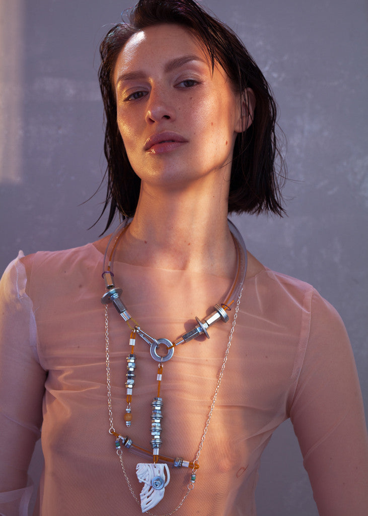 We craft the strongest base for all your experiences and keep them safely. So it consists of building materials such as screws, cable covered by plastic and transperant plastic tube. The white detail is also handmaded and carefuly made of melted plastic. Necklace is also decorated with Baltic Amber. Every Mellow piece has it's own life code, so do this one - N4/018. As well it means this product is one of the kind.