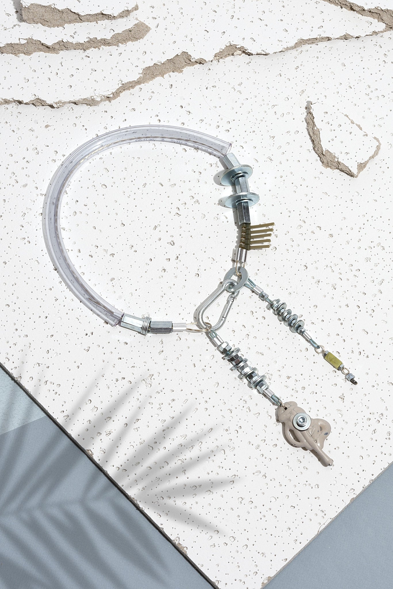 We craft the strongest base for all your experiences and keep them safely. So it consists of building materials such as screws, cable covered by plastic and transperant plastic tube. The nude detail is also handmaded and made of melted plastic. Necklace is also decorated with Amazonite mineral stone. Every Mellow piece has it's own life code, so do this one - N4/014. As well it means this product is one of the kind